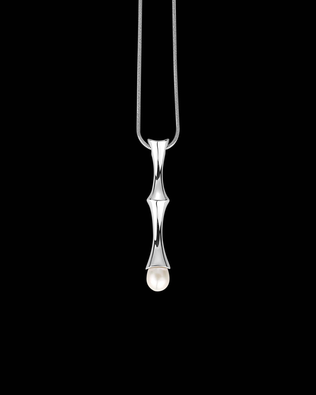 A silver pendant necklace featuring a polished silver bamboo stalk design with a small white teardrop bead at the bottom, suspended from a fine silver chain against a solid black background.